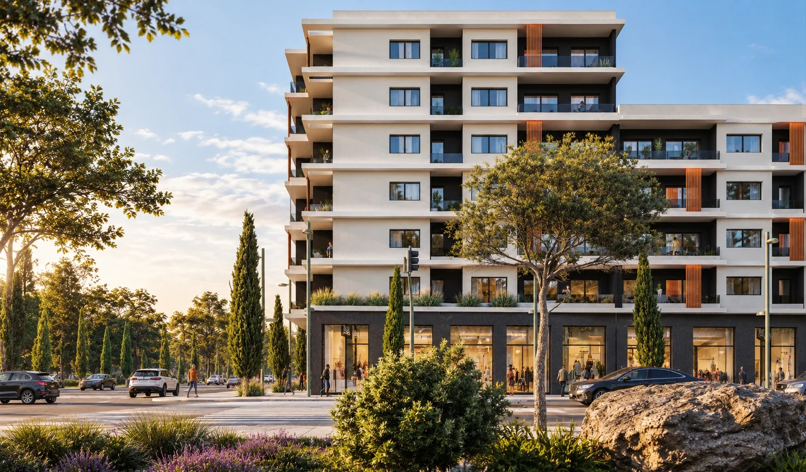 Façade d'Amina Hills dans la lumière du soir : balcons plantés, lames verticales, arbres et vitrines